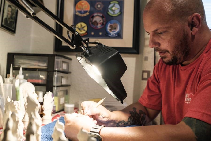 Image of an AYGU HANDYMAN working on a piece of art