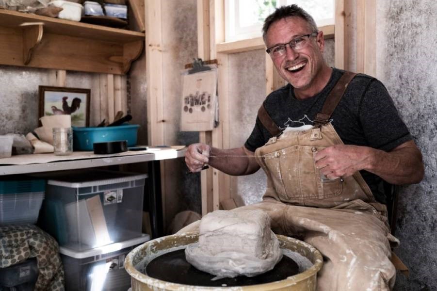 Image of an AYGU HANDYMAN using a pottery wheel