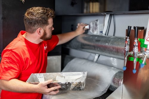 Craftsman repairing restaurant interior finish surfaces