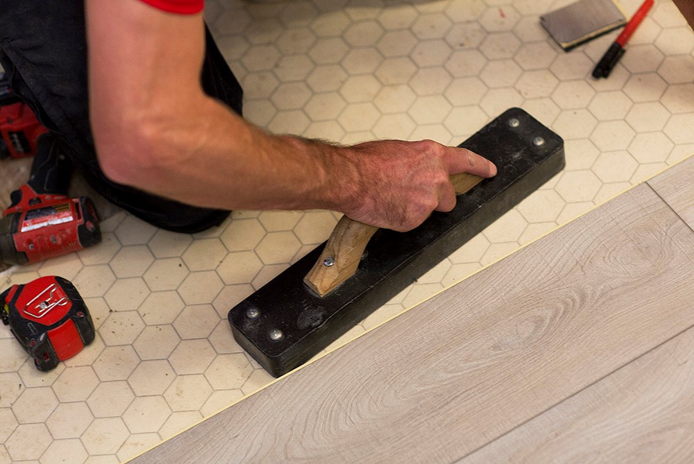 Handyman repairing flooring