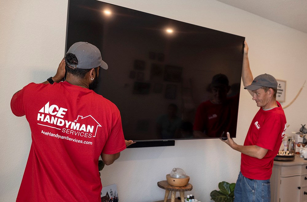image of handymen mounting TV