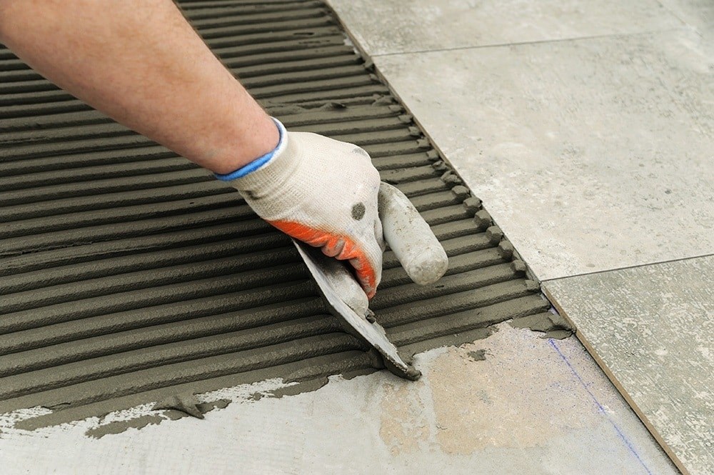 image of someone installing floor tiles