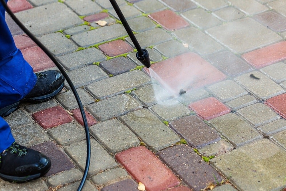 image of someone power washing bricks