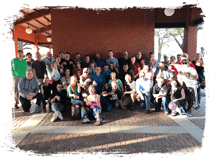 Image of about 30 people gathered for a group photo Image of about 30 people gathered for a group photo