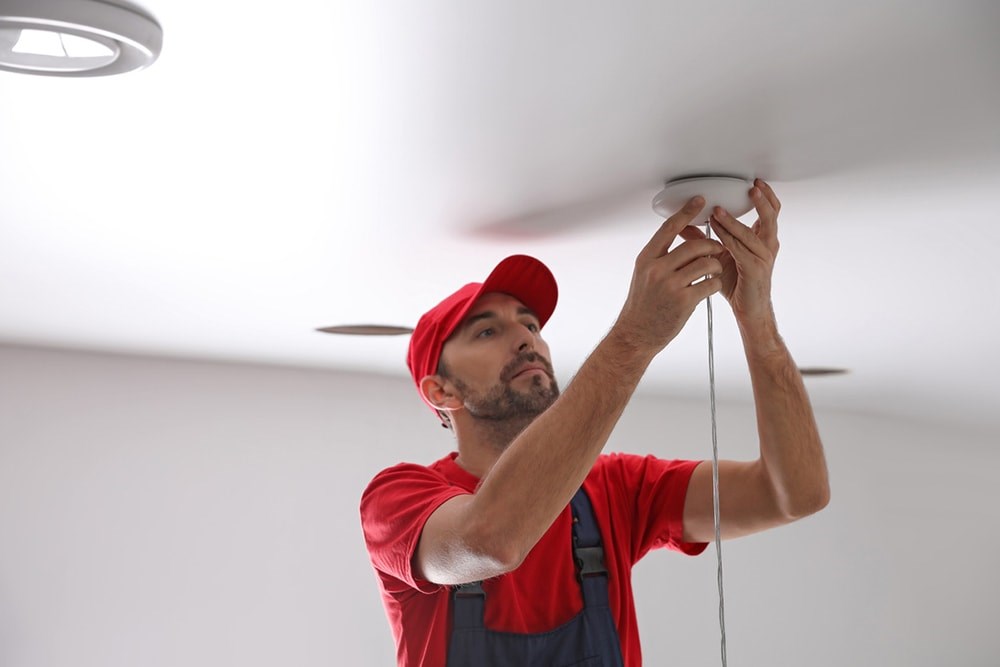 image of someone installing a light fixture