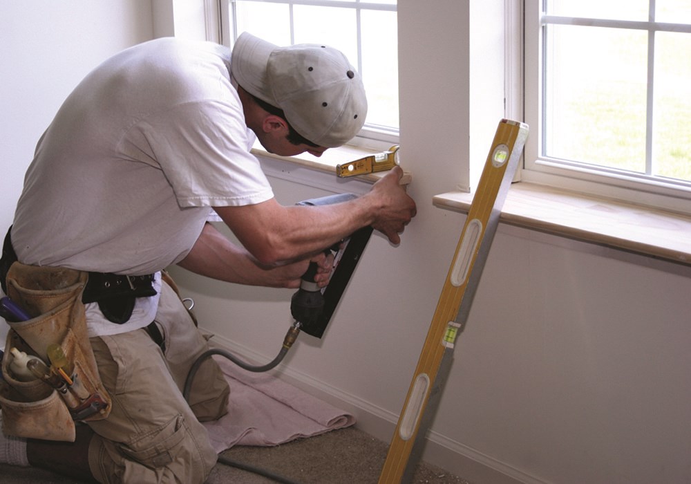 photo of a person repairing a window sill