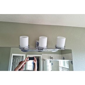 Before photo of new bathroom light fixture installed in Cherry Hills Village, CO