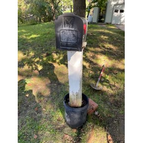 Old mailbox in a bucket