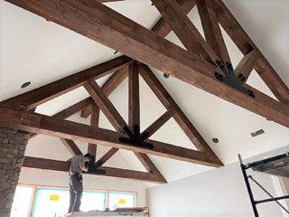 The Craftsman completing the finishing touches on the fantastic beams.