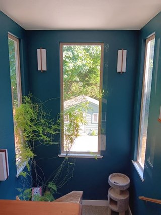 Modern rectangular interior light fixture installed by Ace Handyman Services on a blue wall to illuminate a staircase in Arcata