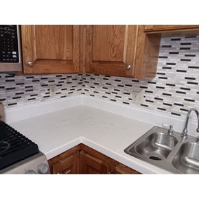 Regrout with white grout on kitchen counter with large white tiles in McKinleyville, CA 