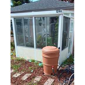 Rain barrel installed by Ace Handyman Services in front of sunroom in Arcata, CA