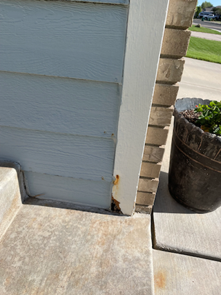 Before: exterior home siding water damage repair
