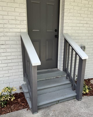 Exterior stair railings freshly painted to enhance curb appeal and provide added protection against weather exposure.