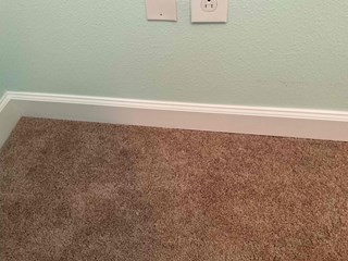 Repaired baseboards restored after moisture damage, featuring clean, smooth trim and fresh finish.
