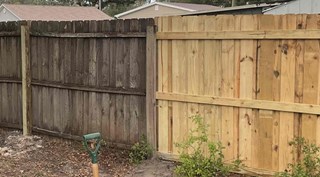 Repaired wooden fence standing straight and sturdy with reinforced posts, professionally restored for safety, stability, and improved curb appeal by Ace Handyman Services of Greater Land O' Lakes