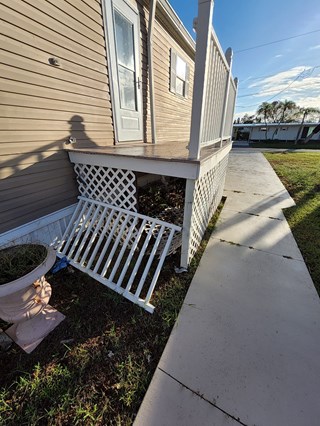 Exterior skirting and railing repair needed