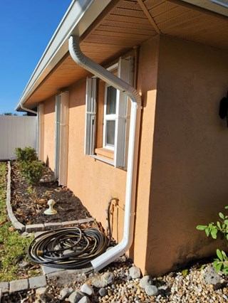 Gutter and downspout reattached to home