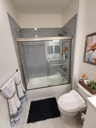 Glass shower door added onto bathtub