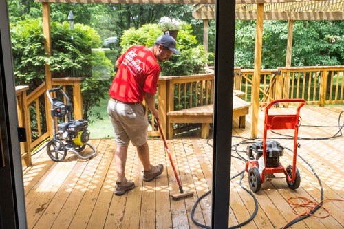 Ace Handyman power washing a deck in Illinois