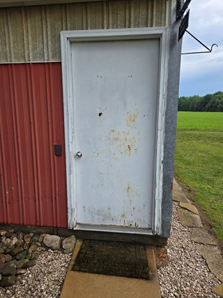 Pole barn door in need of replacement.