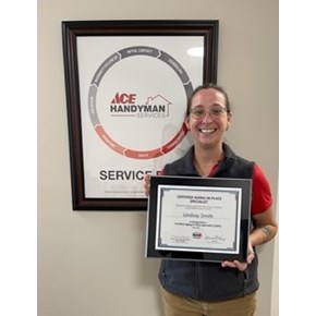 Owner Lindsay Smith Holding CAPS Plaque at Ace Handyman Services Traverse City