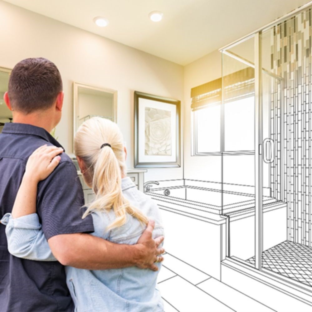 A couple embraces and looks at a life-sized drawn rendering of their bathroom as it transforms into a real-life completed project. 