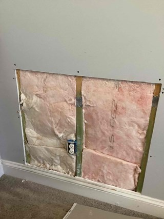 Drywall cutout before repair in Clayton, NC. 