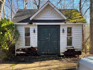 Shed with wood rot before repair. 