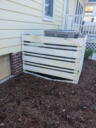 HVAC fence surround before repairs in Southport, NC