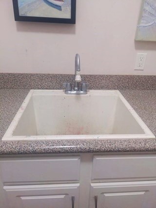 Utility sink and faucet before replacement in Southport, NC