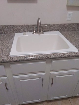 Utility sink and faucet after replacement in Southport, NC