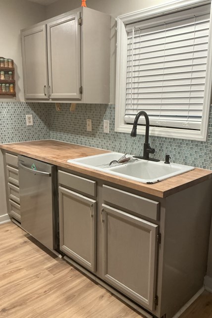 Refreshed Durham kitchen with gray painted cabinets, glass tile backsplash, and butcher-block countertop Refreshed Durham kitchen with gray painted cabinets, glass tile backsplash, and butcher-block countertop
