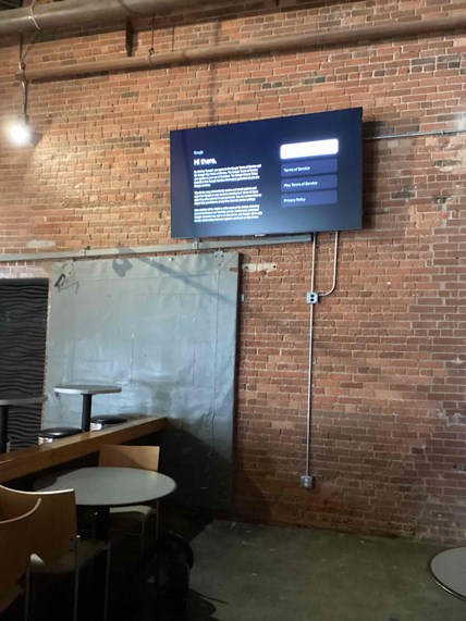 Wall-mounted TV with concealed conduit, commercial handyman job in Durham, NC