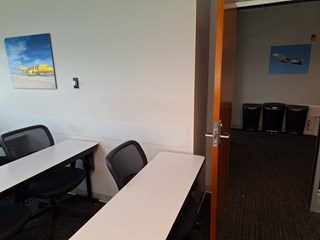 The same classroom, but now a white wall guard is installed along the lower part of the wall. The scuff marks from the "before" image have been covered, and the wall guard will prevent future damage. 