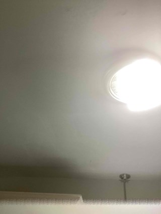 he taped openings from the previous image are no longer present, and the ceiling surface has been repaired.