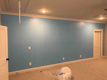 Completed interior painting in a Wake Forest, NC home for repeat customer Roy T. new blue accent wall, refreshed white crown molding, and trim touch-up.