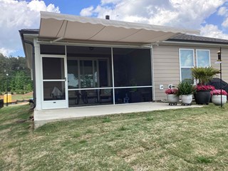 Porch, now with an added retractable awning above, providing shade and protection from the elements.