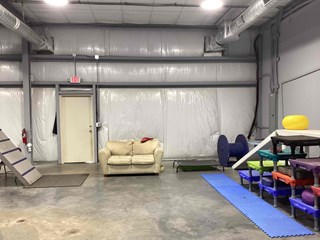 Dog training space with walls covered by plastic sheeting and insulation. 