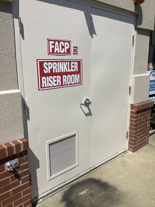 Sprinkler Riser Room door after it has been painted. The surface appears spotless, with no visible smudges or dirt marks