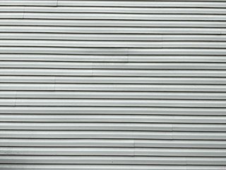 Section of siding after the repair. The siding is now smooth and aligned, with the gap properly filled.