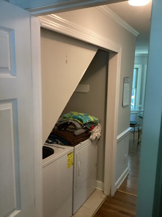 Laundry closet with sliding doors fallen in.  