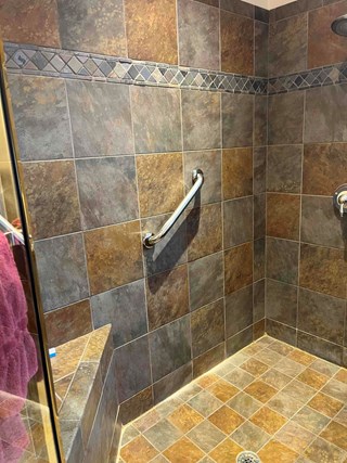 Tile shower wall after a grab bar has been installed. 