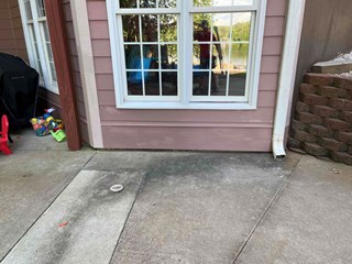 The repaired siding, where the damaged area has been addressed. The siding is now smooth and intact, and the previously exposed area has been restored to match the surrounding wall