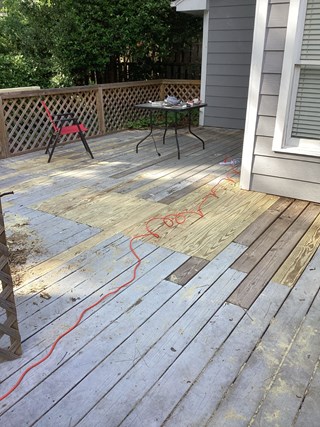 The damaged planks have been replaced with new wood, creating a more even surface. 