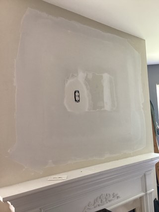 The drywall around the alcove has been patched and finished, with the surface smooth and ready for painting.  The old area has now been closed off and is ready for a TV mounting. 