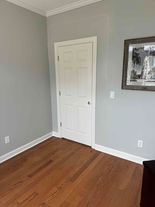 Completed door, with the trim installed around the door frame. The wall looks finished, and the door now has a more polished and complete appearance.