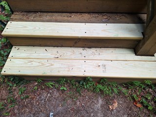  The old, damaged step boards have been replaced with new, clean wooden planks, making the steps look well-maintained and sturdy again.