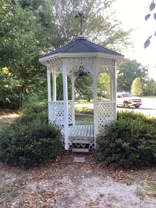 Gazebo has been freshly painted, with the wood now looking refreshed.