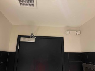 Graffiti has been removed. The wall is now clean, with no signs of the previous spray paint, restoring a tidy and neat appearance to the area.